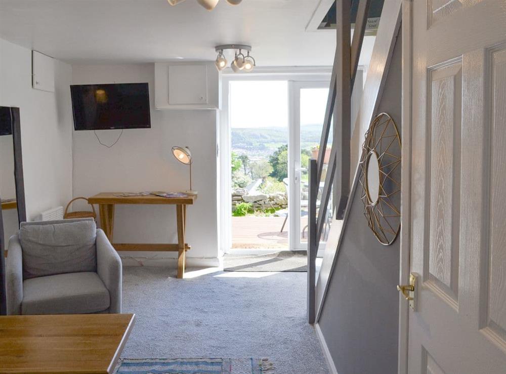 Living area with French doors and stairs to the upper level at The Annex in Llandudno, Conwy, Gwynedd