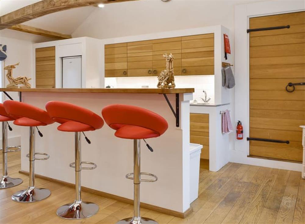 Modern kitchen area with breakfast bar at The Annexe in Jervaulx, near Ripon, North Yorkshire