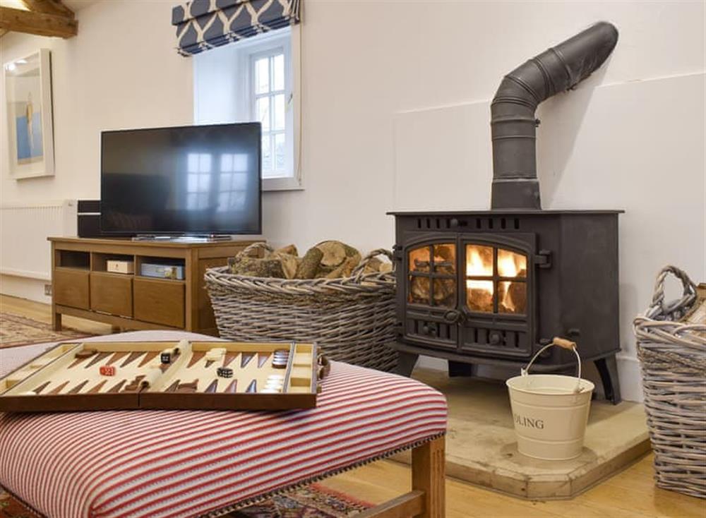 Welcoming living area with wood burner at The Annexe in Jervaulx, near Ripon, North Yorkshire
