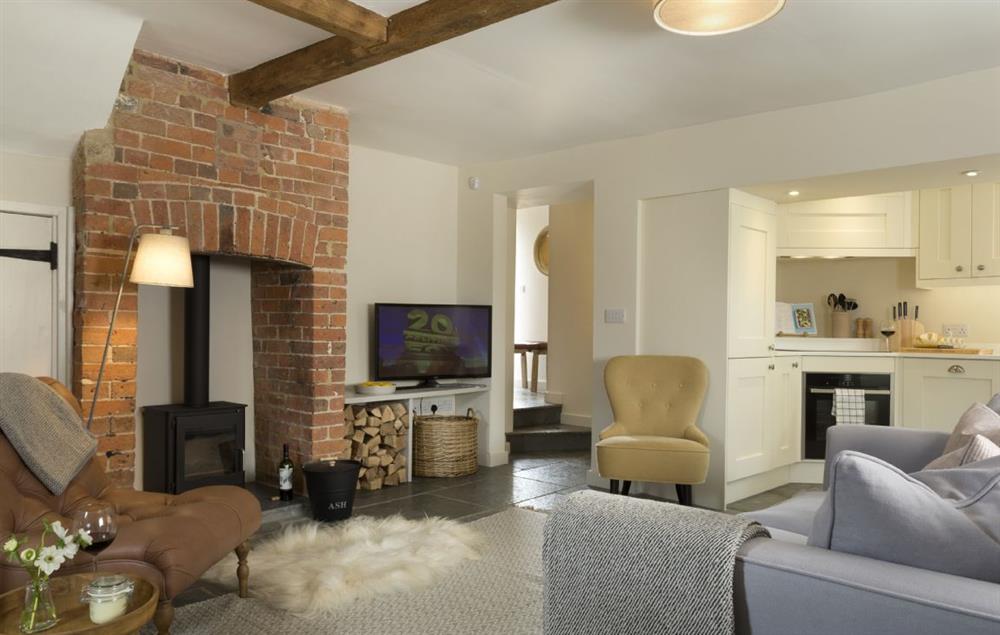 Open plan living area with wood burning stove at The Bakery, Stretton-on-Fosse