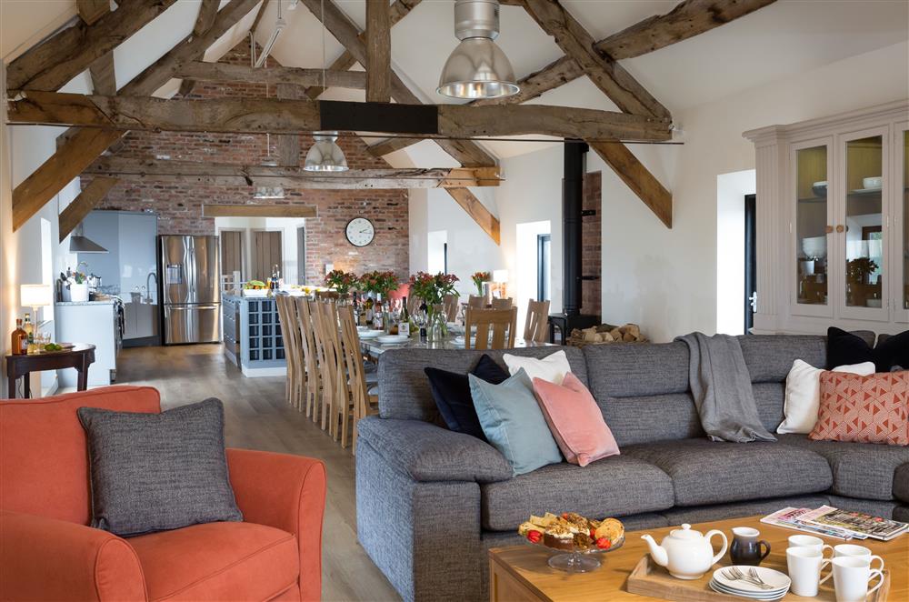 Spacious, open-plan sitting, dining and kitchen area on the first floor with exposed beams  (photo 2) at The Barn at Plas Ashpool, Llandyrnog