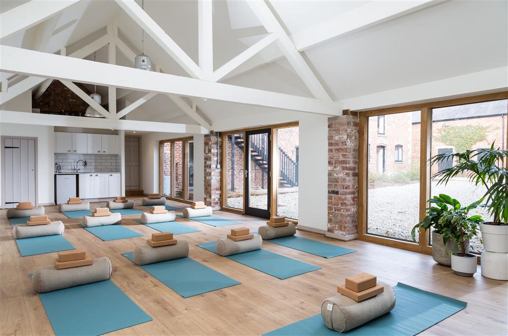 The studio space transforms into a wellness space complete with yoga mats and floor to ceiling windows