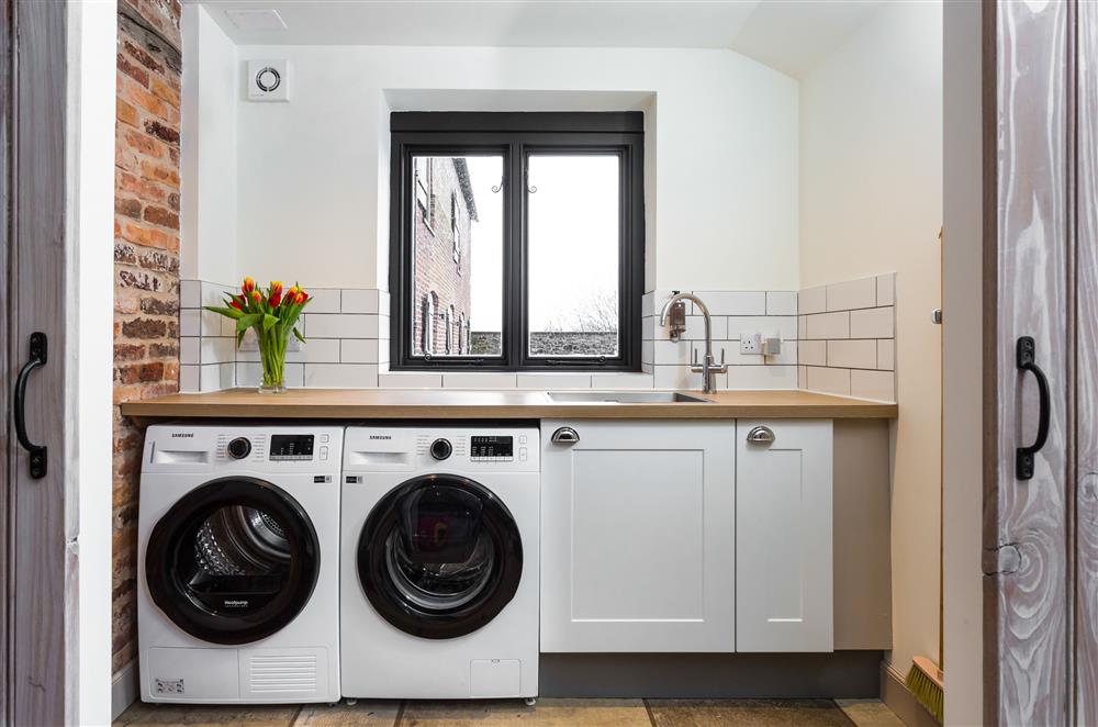 Utility room with a washing machine and tumble dryer