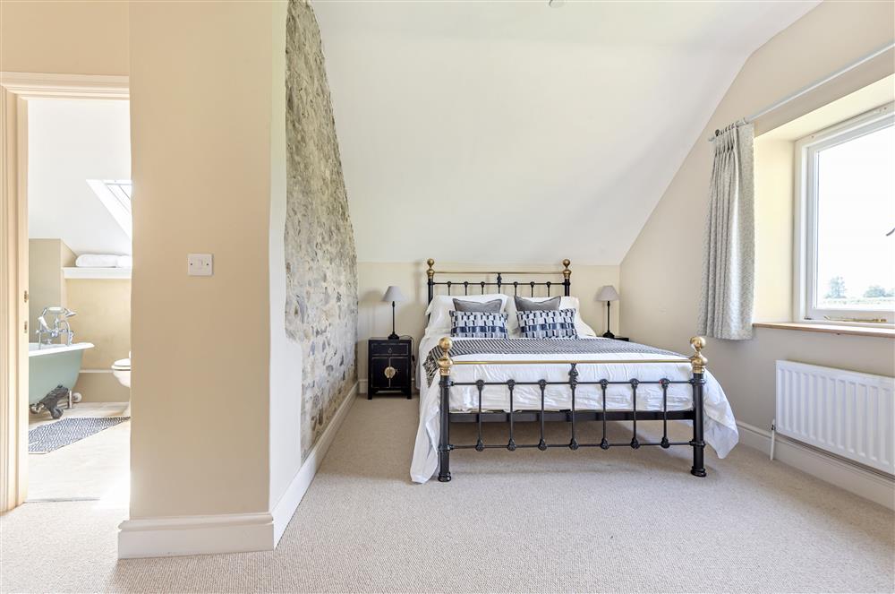 Bedroom one with en-suite bathroom at The Barn, Chard, West Dorset
