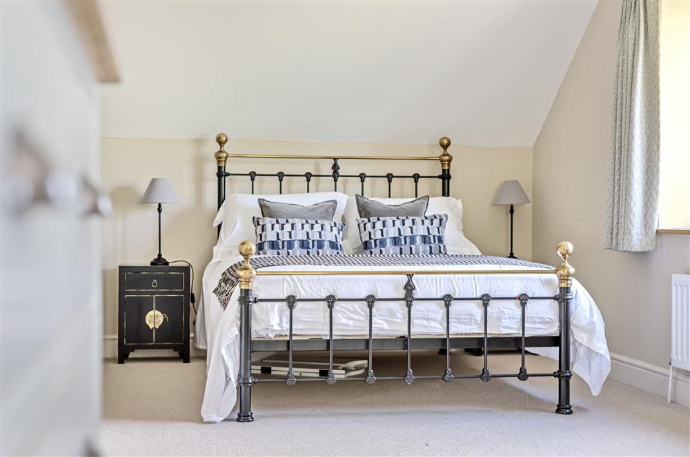 Spacious bedroom one with a 5’ king-size bed at The Barn, Chard, West Dorset