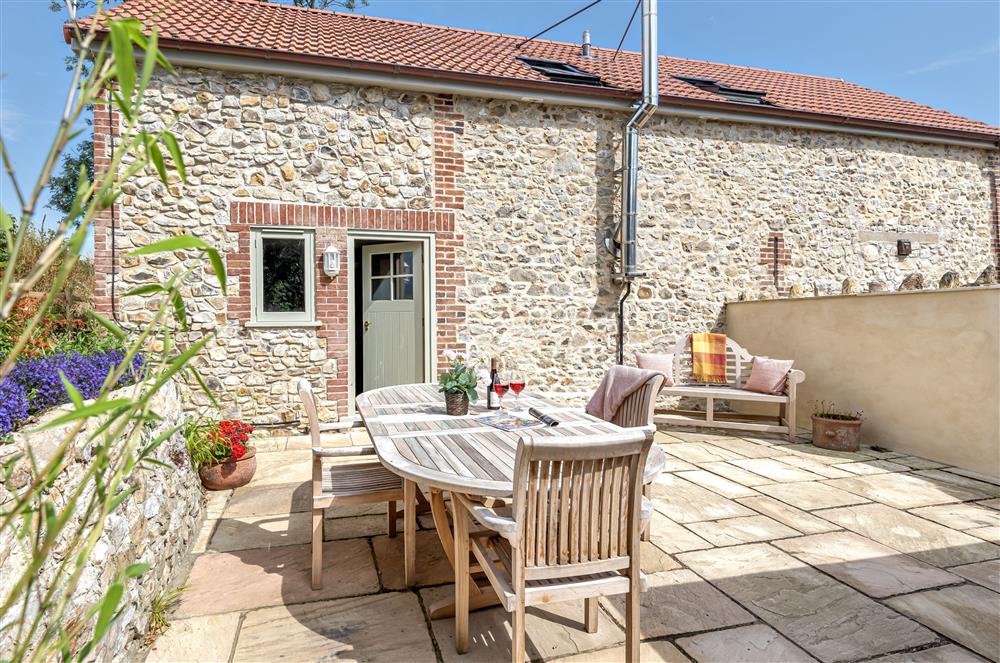 The sunny courtyard garden is ideal for alfresco dining at The Barn, Chard, West Dorset