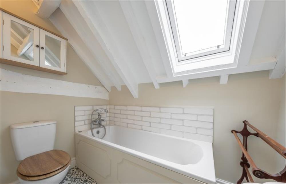 First floor: Bathroom with bath with hand-held shower at The Barn, Great Ryburgh near Fakenham