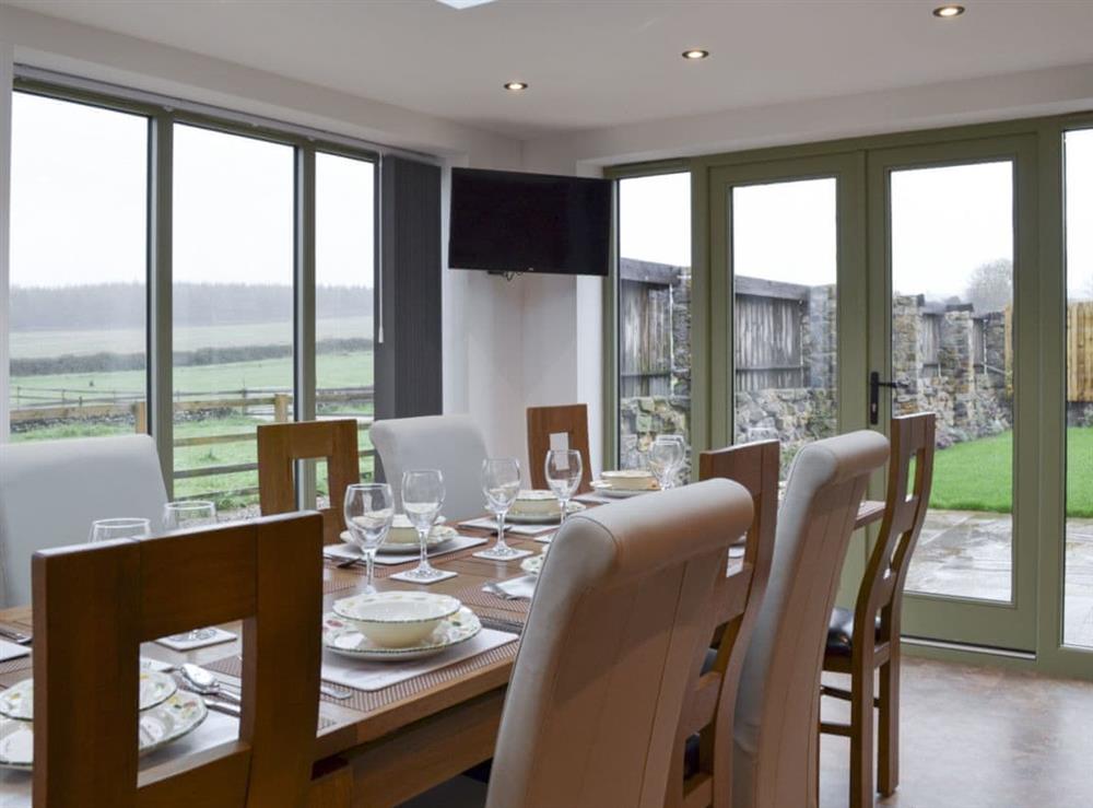 Dining area with French doors at The Barn in Harwood Dale, near Scarborough, North Yorkshire