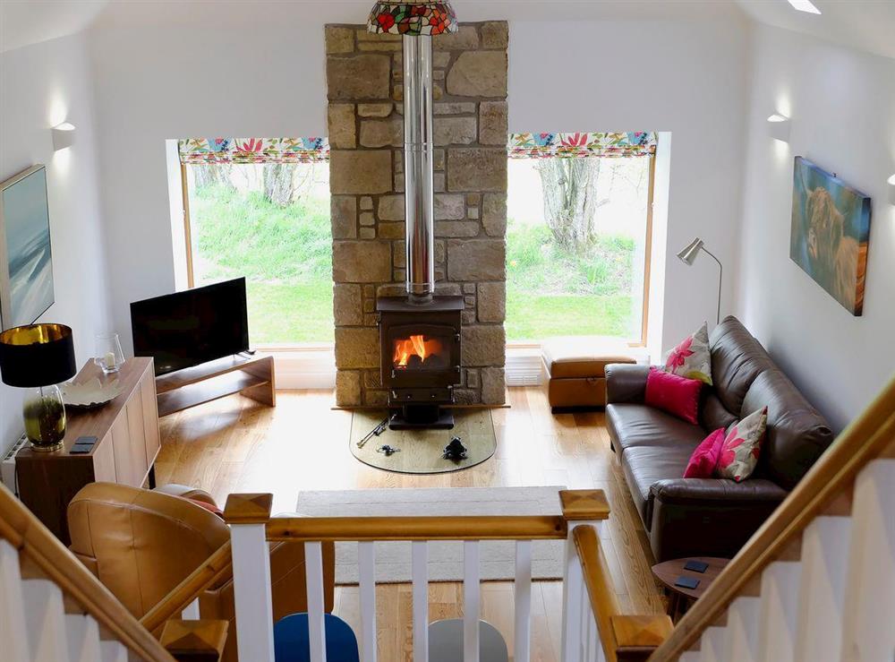 Comfy living area with wood burner at The Barn in Kildary, near Tain, Highlands, Ross-Shire