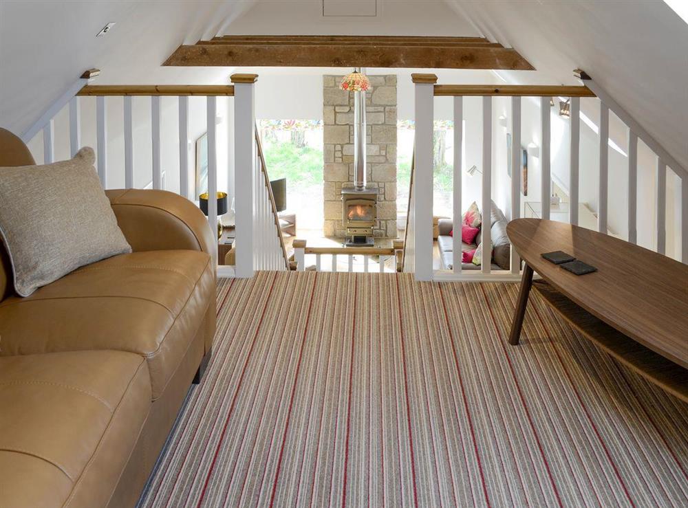 Galleried second living area with sofa bed at The Barn in Kildary, near Tain, Highlands, Ross-Shire