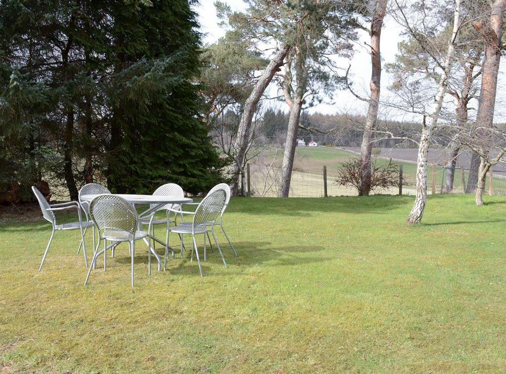 Lawned area of garden with outdoor furniture at The Barn in Kildary, near Tain, Highlands, Ross-Shire