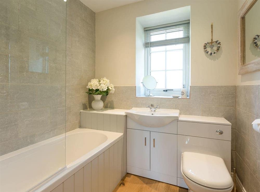 En-suite bathroom with shower over bath at The Barn, Oak Tree Farm in West Witton, near Leyburn, Yorkshire, North Yorkshire