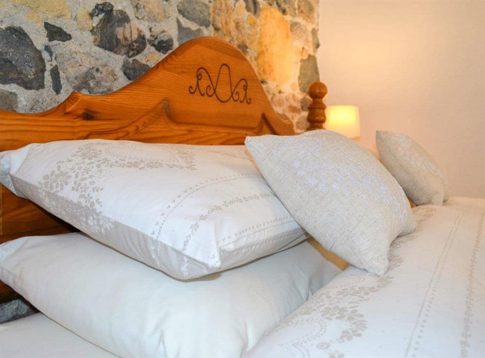 Sumptuous double bed with crisp white linen at The Barn in St Austell, Cornwall