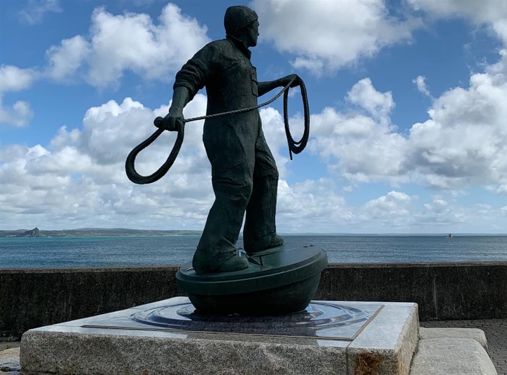 Newlyn fishermen statue at the start of the boardwalk and just around the corner from the cottage at The Basket Loft in Newlyn, Cornwall
