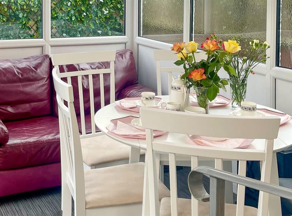 Dining area within the sun room at The Bay Cottage in Thornton-Cleveleys, Lancashire