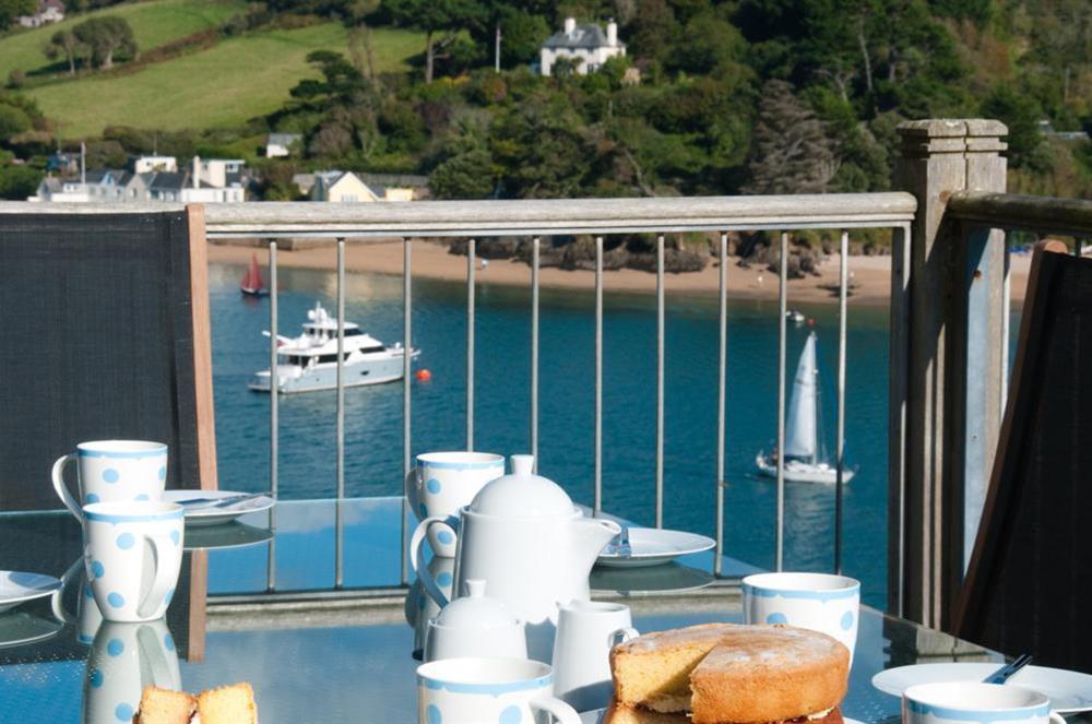 The Beach House has a large decking area with table and chairs at The Beach House (Woodside) in Bennett Road, Salcombe