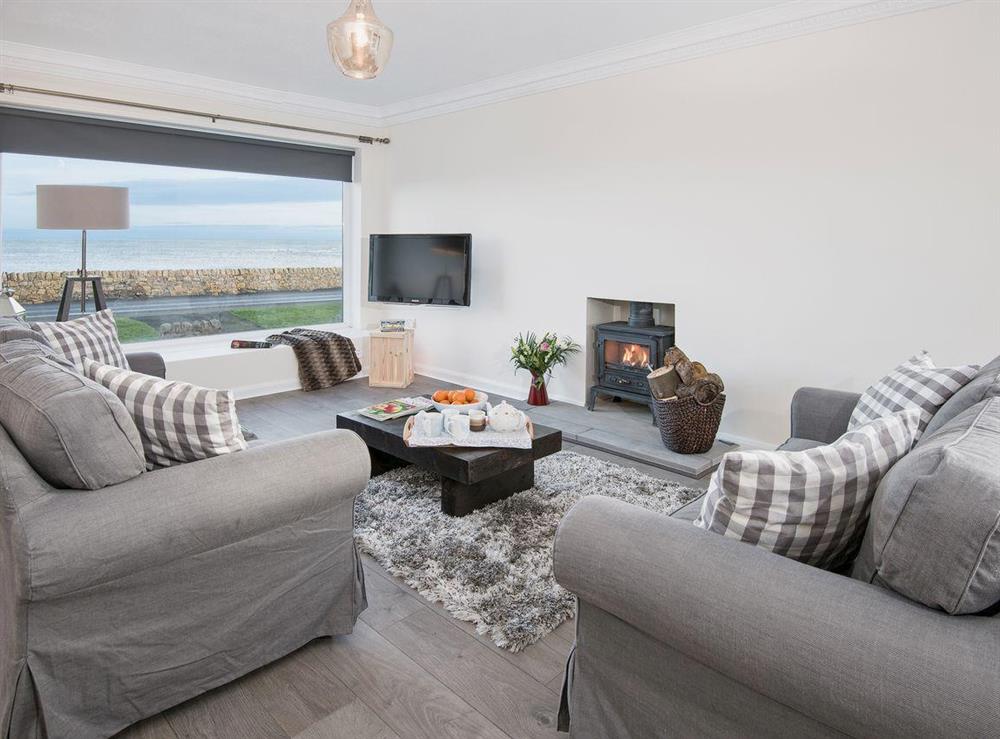Living area with wood burner and seal view at The Beach House in Chathill, Northumberland