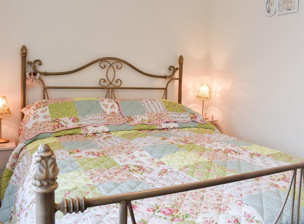 Bedroom boasting a kingsize antique style double bed at The Beach House in Holland-on-Sea, Essex