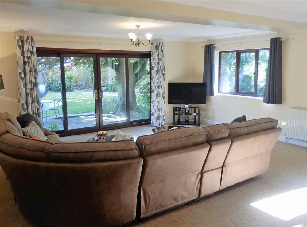 Spacious living room with patio doors to garden (photo 2) at The Beech House in Corton, near Lowestoft, Suffolk