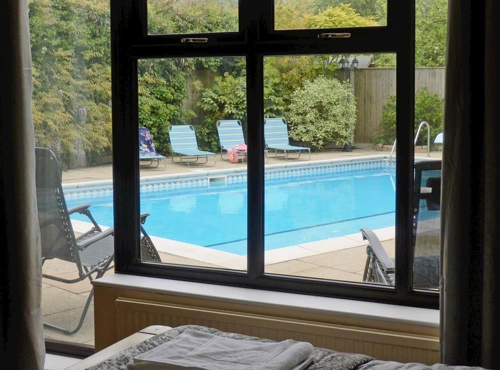 Swimming pool view from bedroom at The Beech House in Corton, near Lowestoft, Suffolk