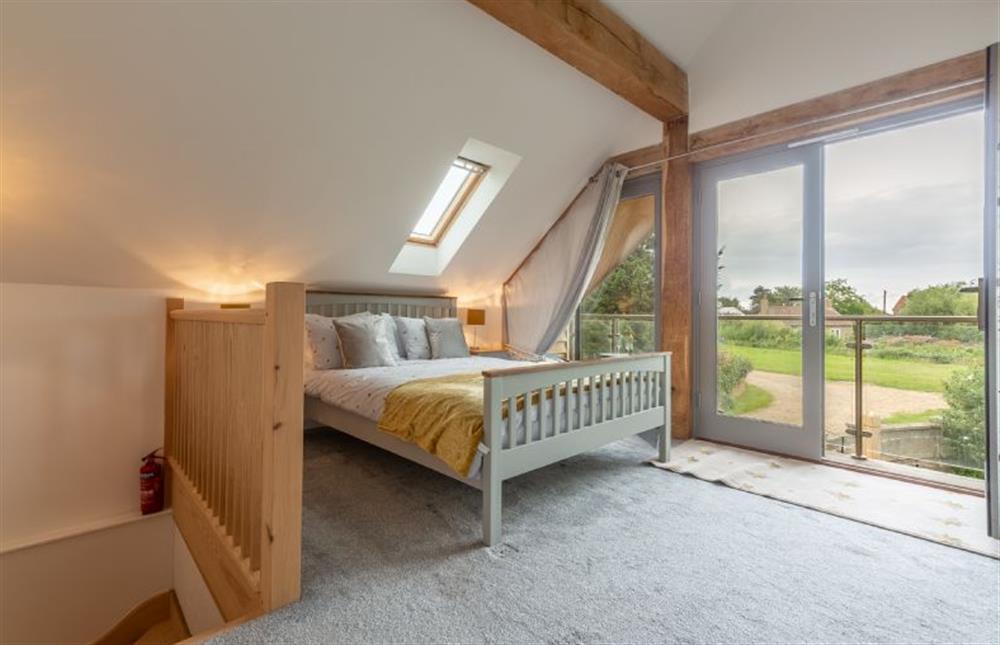 Master bedroom with decked balcony at The BeeHive, Old Hunstanton
