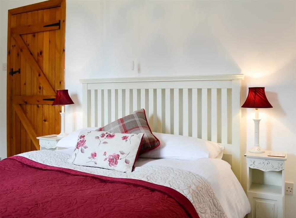 Pretty bedroom with double bed at The Bellringers Cottage in Llandegla, near Wrexham, Denbighshire