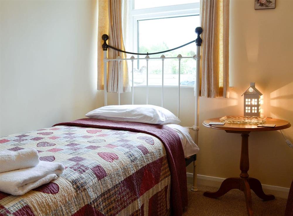 Twin bedroom with antique style single beds at The Bellringers Cottage in Llandegla, near Wrexham, Denbighshire