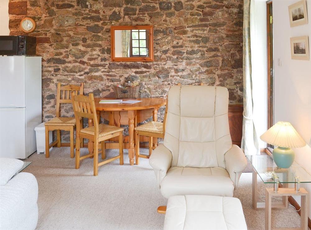 Modest dining area with exposed stone wall at The Berry in Marldon, near Paignton, Devon