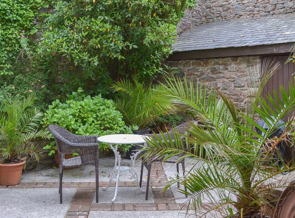 Paved patio garden with outdoor furniture at The Berry in Marldon, near Paignton, Devon