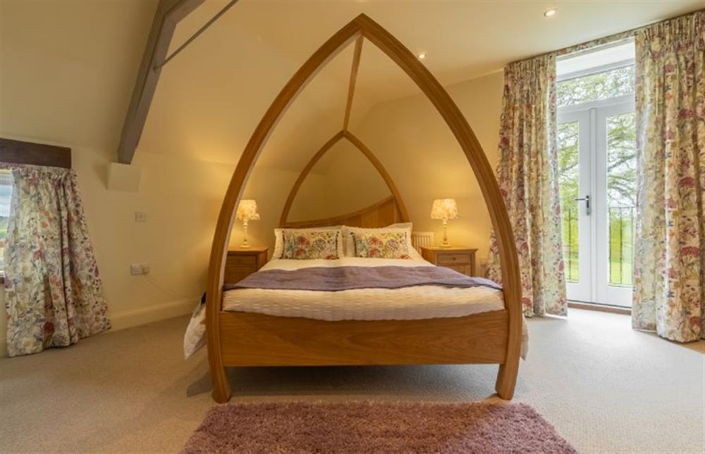 First floor: A bespoke four posted bed in the master bedroom at The Big Barn, Snettisham near Kings Lynn