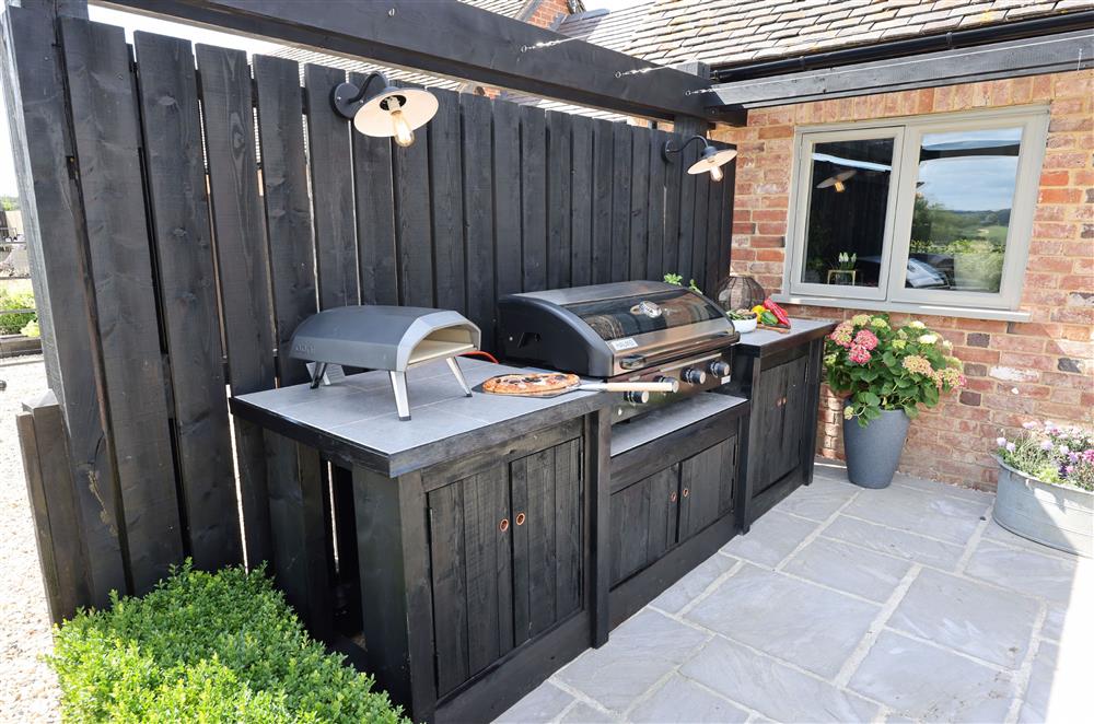 The stunning outdoor kitchen, with a barbecue and pizza oven  at The Big Barn, Walton, Near Stratford-upon-Avon