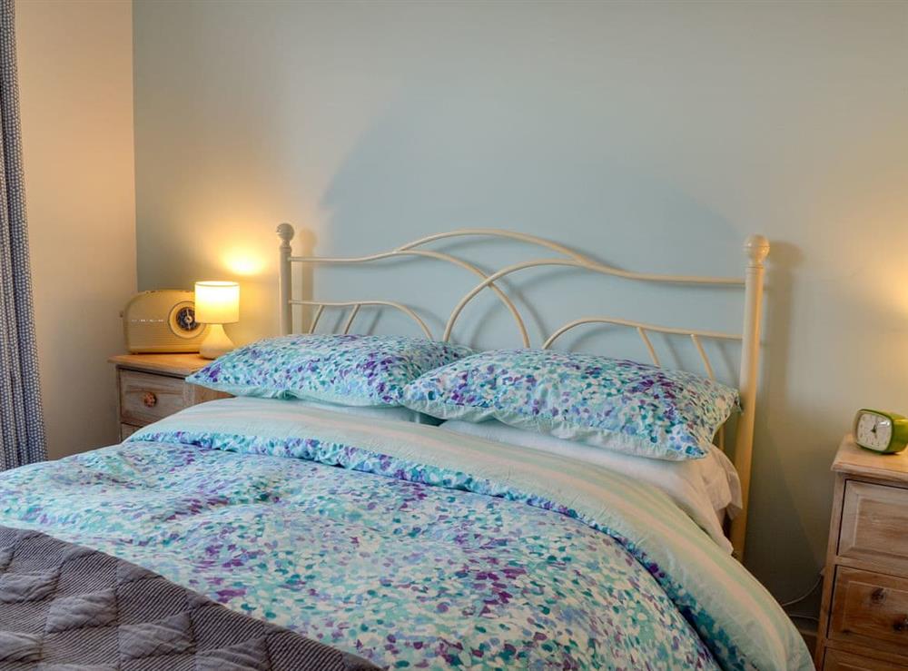 Bright and airy double bedroom with French doors leading to decked terrace at The Blue Loft in Playden, near Rye, East Sussex