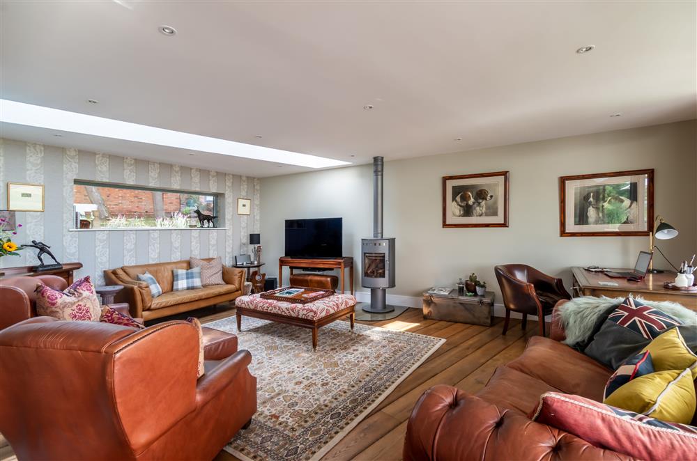 The sitting room enjoys a wood burning stove and sumptuous seating