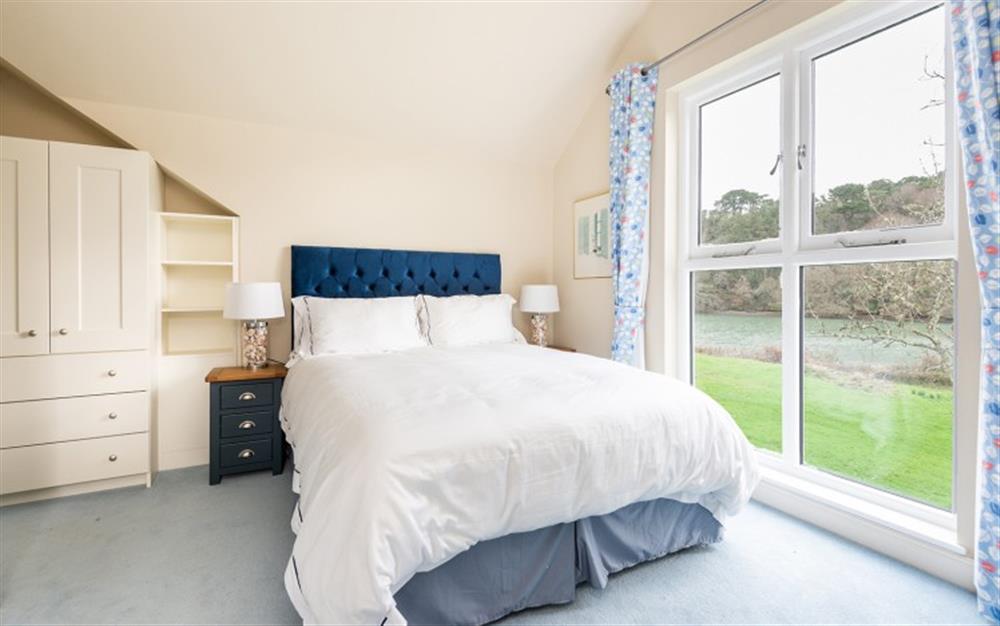 The master bedroom with stunning views  at The Boathouse in East Portlemouth