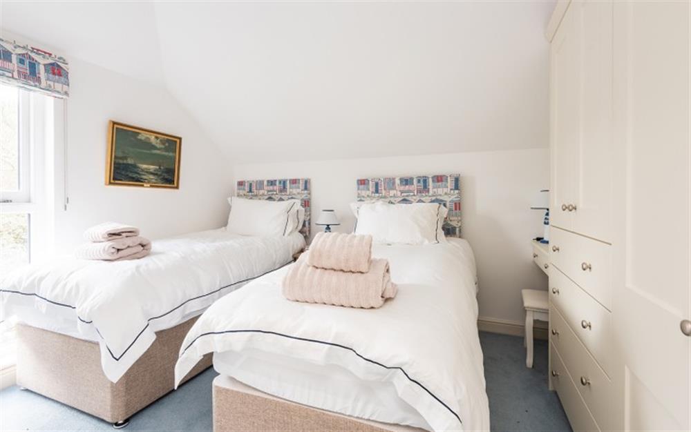 The pretty twin room with fitted wardrobes and a picturesque view from the window at The Boathouse in East Portlemouth