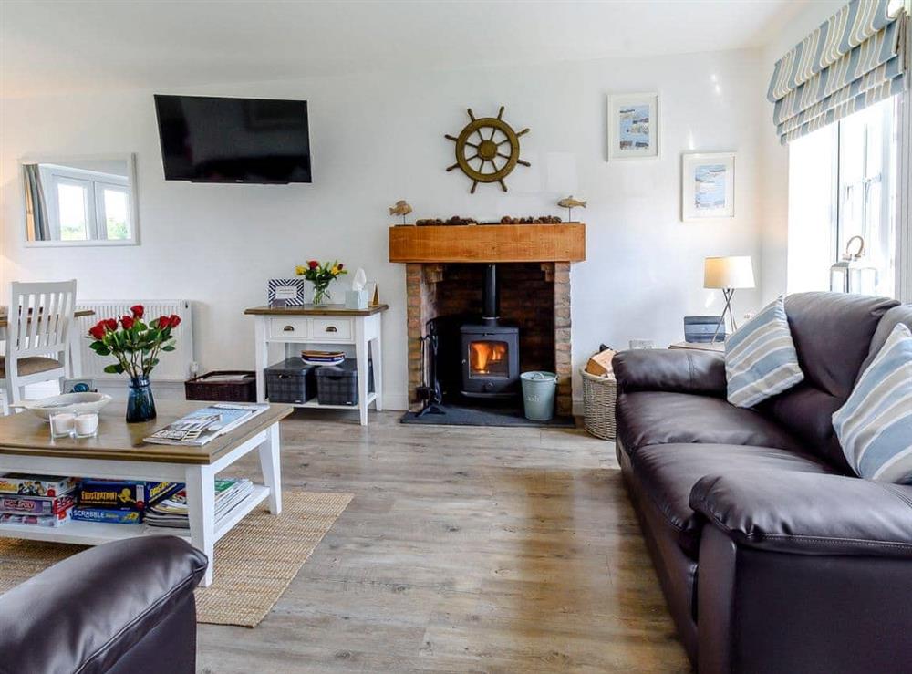 Welcoming living area with wood burner at The Bolthole in Hunmanby Gap, near Filey, North Yorkshire