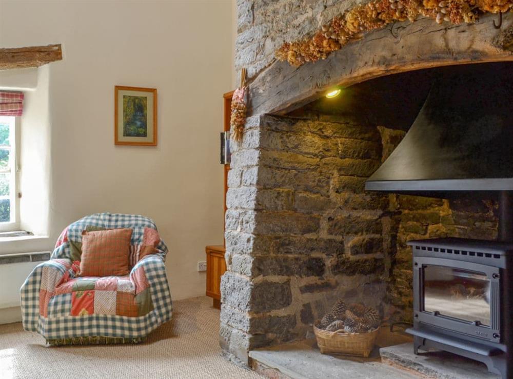 Rustic style living room with large inglenook fireplace at The Bothy in Bucknell, Shropshire