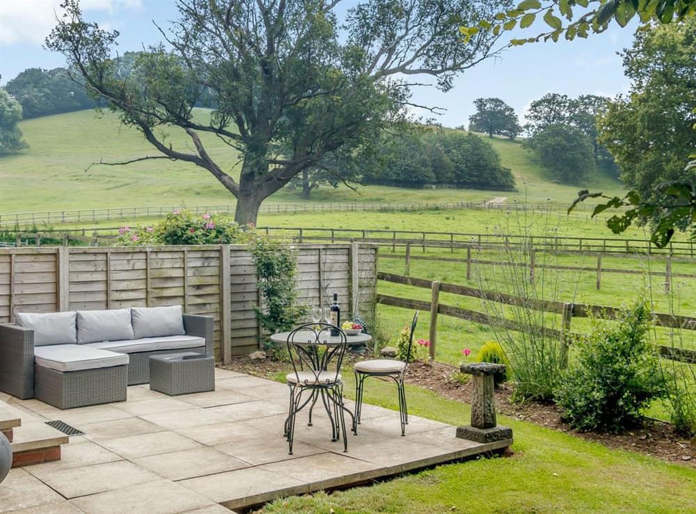 Paved patio with a range of garden furniture at The Bothy in Mathon, near Malvern, Herefordshire