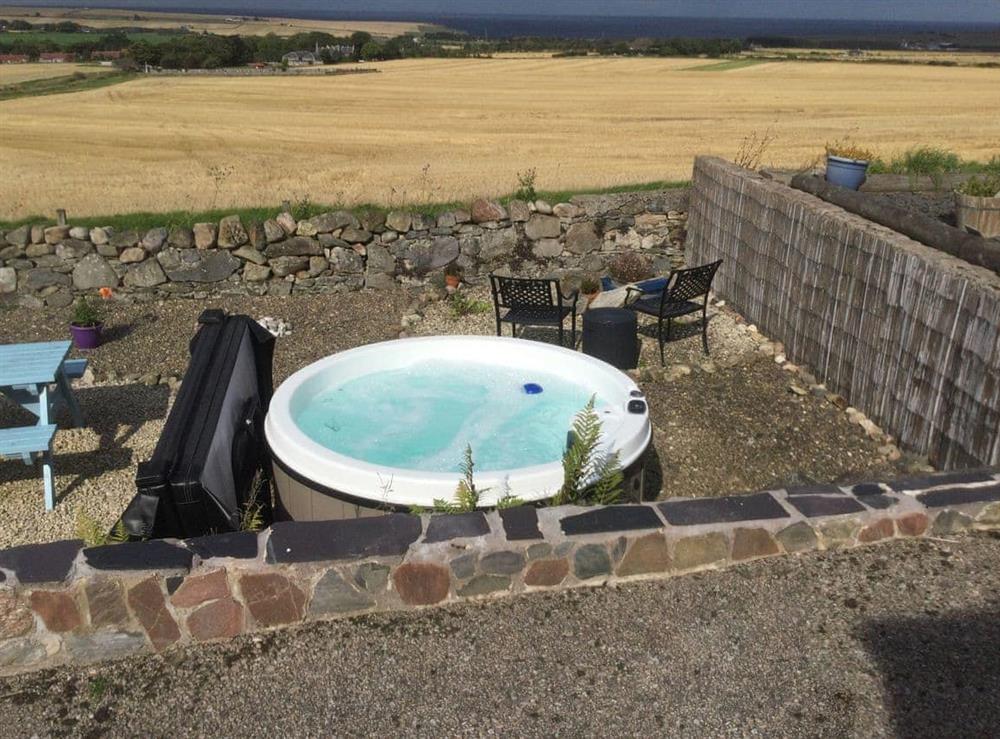 Hot tub with uninterrupted panoramic views towards the coast at The Brae Steading in Fordyce, Aberdeenshire