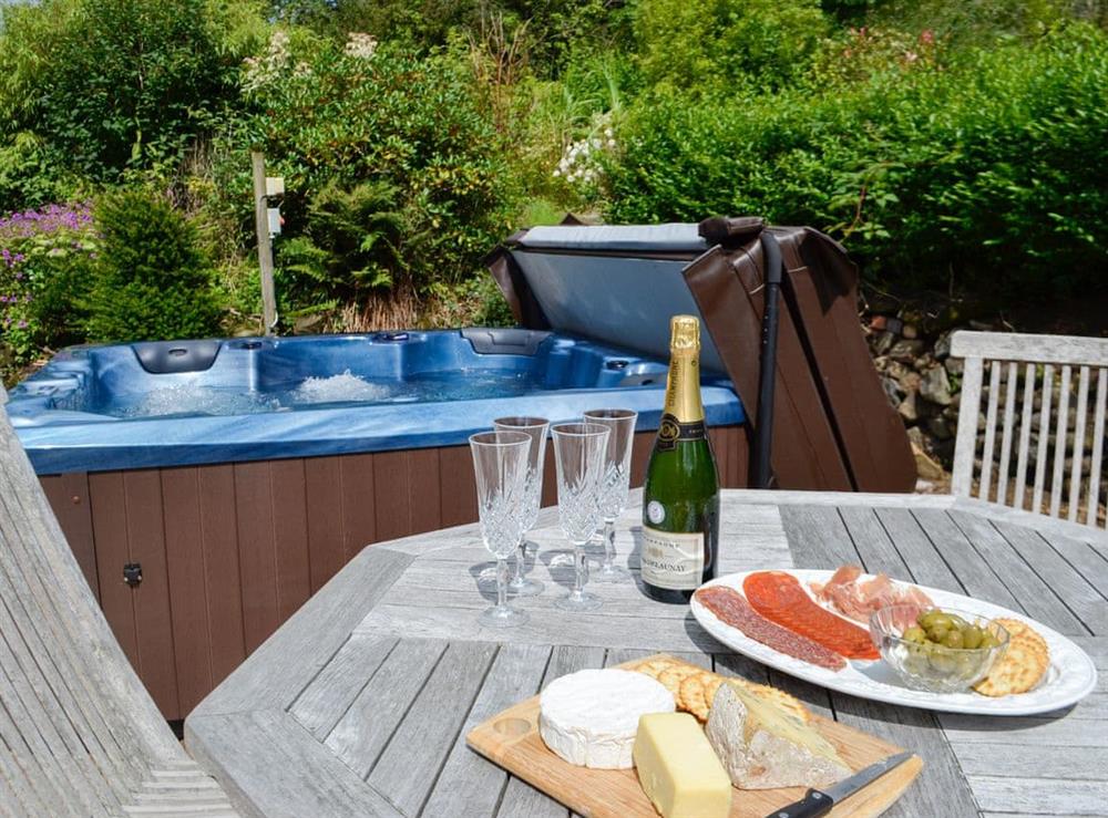 Outdoor area with hot tub at The Brewers Cottage in Near Mauchline, Ayrshire