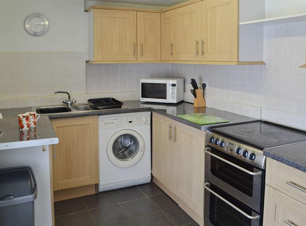 Well-equipped fitted kitchen at The Bridge Inn Flat in Bridgerule, near Bude, Devon