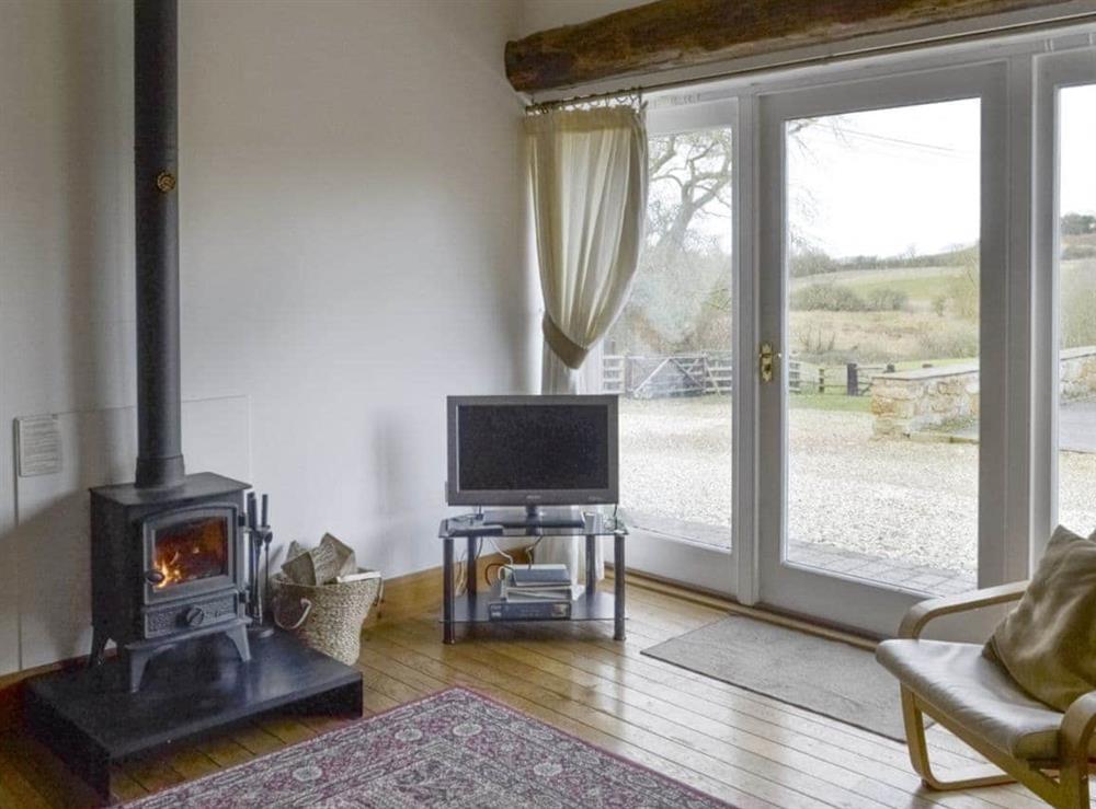 Warming wood burner within living area at The Bridles  in Lincolnshire Wolds, near Market Rasen, Great Britain
