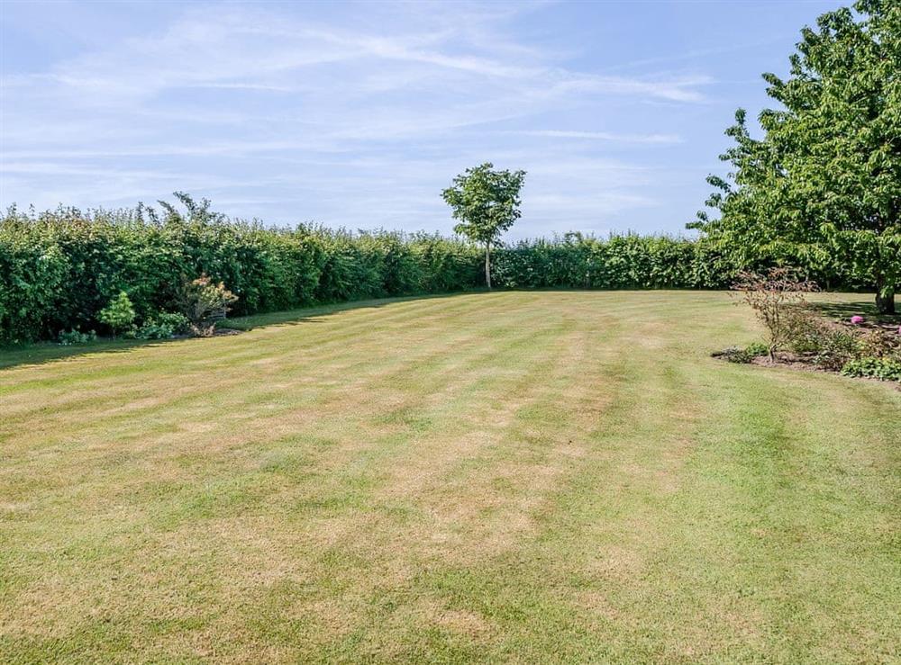 Large lawned garden at The Bull Pen in Lawford, Essex, England