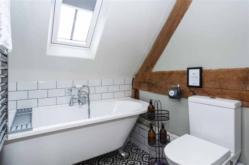 Bedroom three’s en-suite with a roll-top bath and hand-held shower attachment and underfloor heating