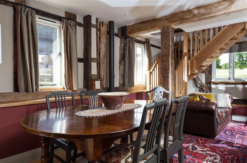 Dining area with oak dining table seating all guests at The Byre, Bridgnorth