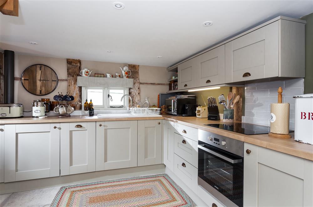 Kitchen with an electric oven and hob, dishwasher and coffee machine at The Byre, Bridgnorth