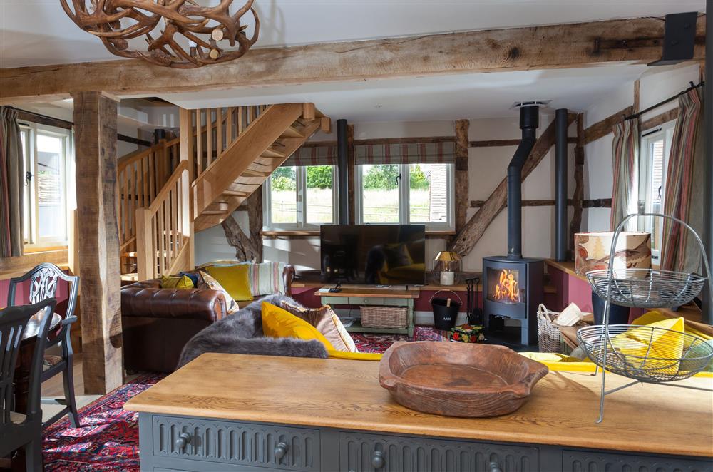 Open-plan sitting and dining area with exposed beams at The Byre, Bridgnorth