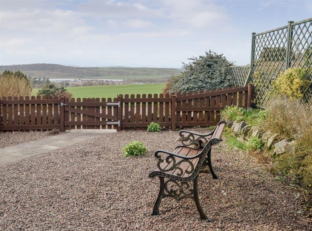 Enclosed patio area with views over the surrounding area at The Byre Cottage in Cannee, near Kirkcudbright, Dumfries and Galloway, Kirkcudbrightshire
