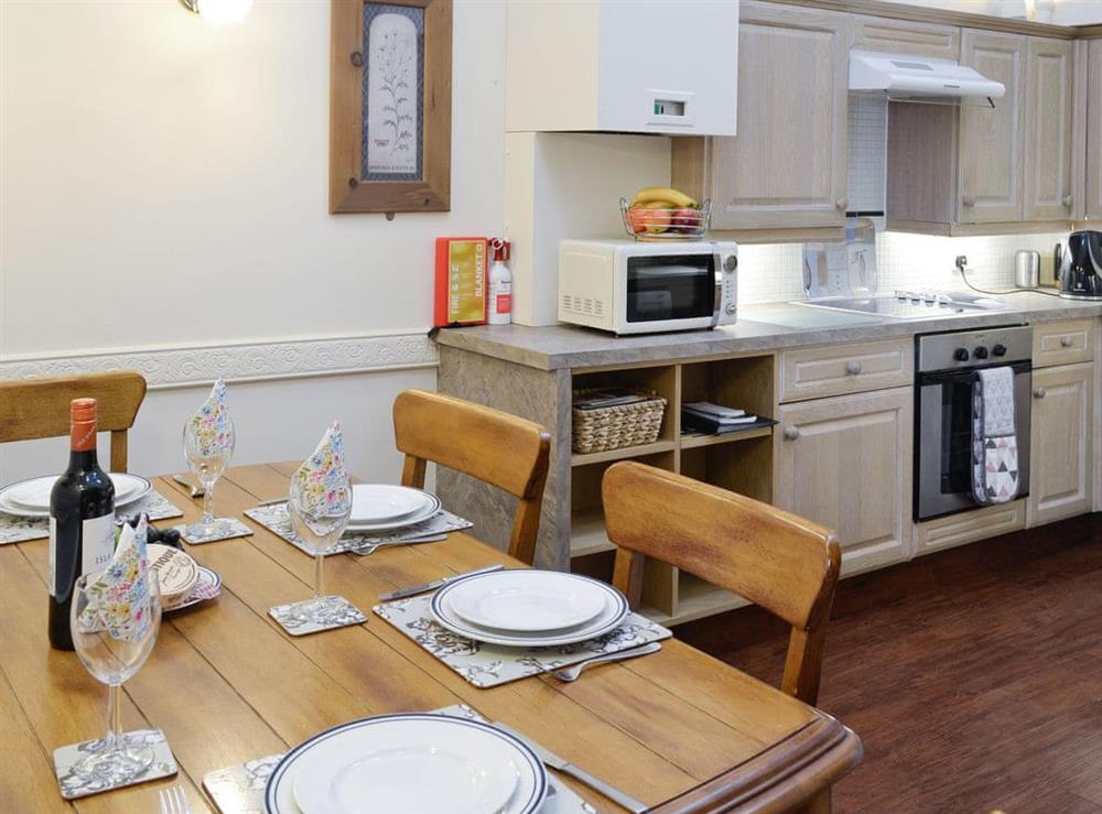 Well-equipped kitchen with dining area at The Byre Cottage in Cannee, near Kirkcudbright, Dumfries and Galloway, Kirkcudbrightshire