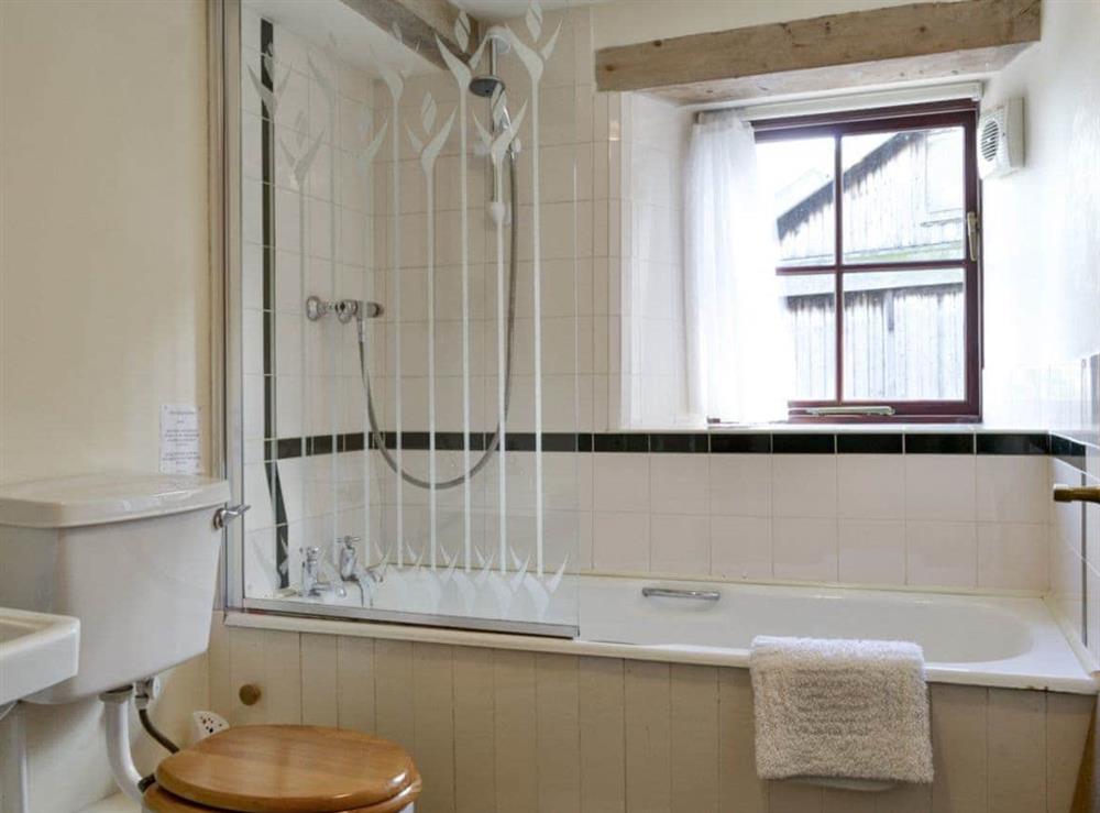 Family bathroom with shower over bath at The Byre in Newby, near Appleby-in-Westmorland, Cumbria